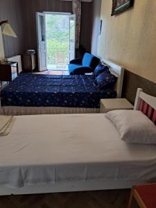 a bedroom with two beds and a door to a patio at Guest House Ucha in Mtskheta +50 photos