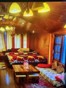 a living room with couches and a table at Jakhu heights B&B in Shimla