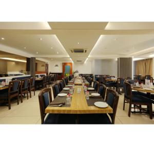 a long dining room with tables and chairs at Hotel Prince, Bhuj in Bhuj