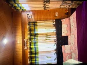 a window with a rainbow curtain in a room at Jakhu heights B&B in Shimla