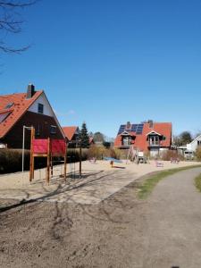 a playground in front of a house with houses at FEWO Turf Watt Nr.5 in Cuxhaven