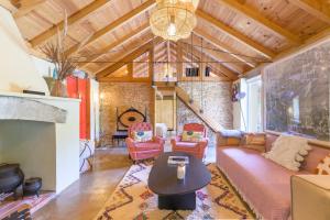 a living room with a couch and chairs and a fireplace at Eclectic Monte Laginha Alentejo in Aldeia do Cano