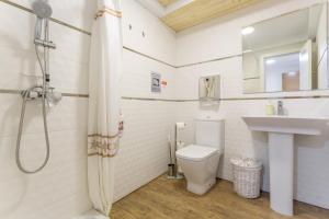 a bathroom with a shower and a toilet and a sink at Las Palmeras 2 in Güimar +17 photos