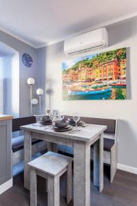 a dining room with a table and a painting on the wall at Il nido di Argegno in Argegno