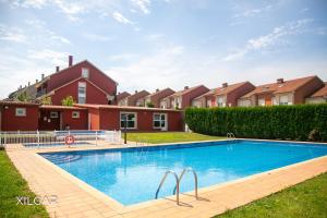 a swimming pool in the yard of a house at Xilgar - Chalet Ensenada de Lanzada in Sanxenxo