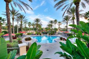an image of a resort pool with palm trees at 25% Off 3BR Disney Area Villa in Davenport