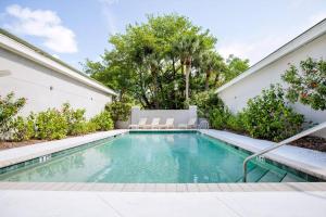 a swimming pool in the backyard of a house at Ibis At The Sanctuary A302 in Sanibel
