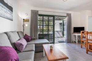 a living room with a couch and a table at Heiwa Apartment With Pool in Costa Calma