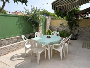 a table and chairs sitting on a patio at WonderStays Chalet El Naranjo in Seville