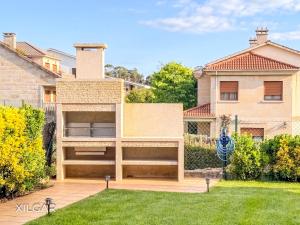 a house with a yard in front of it at Xilgar - Chalet Ensenada de Lanzada in Sanxenxo