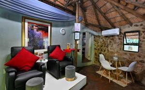 a living room with two chairs and a table at BON Hotel Rustenburg in Rustenburg