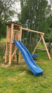 a playground with a blue slide and a swing at Salzleckerhof in Lambach