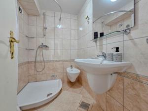 a bathroom with a sink and a shower and a toilet at Ivanka A2 in Dajla +26 photos
