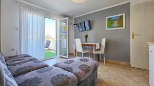 a living room with a couch and a table and a window at Ivanka A2 in Dajla