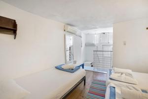 a white room with two beds and a window at Villa Sissy in Kerames +22 photos