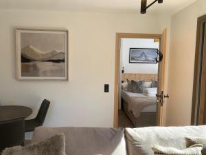 a room with a bedroom with a bed and a mirror at Dents Blanches B103 by Avecoeur in Morzine
