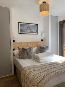 a bedroom with a bed with a picture on the wall at Dents Blanches B103 by Avecoeur in Morzine