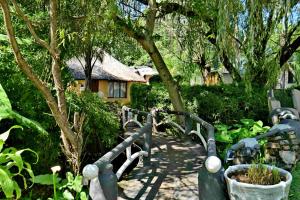 a garden with a fence in front of a house at BON Hotel Rustenburg in Rustenburg