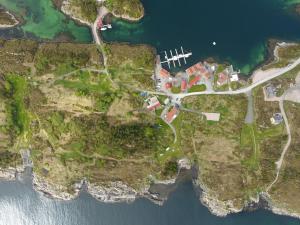 an aerial view of a house on a cliff next to the water at Lysø naturcamping og rorbuer in Averoy