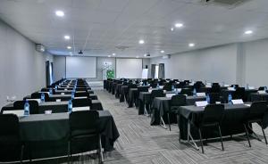 a large room with tables and chairs in it at BON Hotel Rustenburg in Rustenburg +38 photos