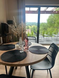 a wooden table with two black plates and wine glasses at Stodoły ForRest in Czarna +18 photos