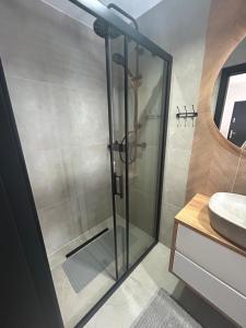 a shower with a glass door in a bathroom at Stodoły ForRest in Czarna
