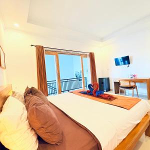 a bedroom with a large bed with a large window at Bali intan Canggu in Canggu