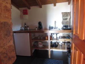 a small kitchen with a counter and a sink at Casa Rústica, perto do Castelo de Óbidos in Óbidos