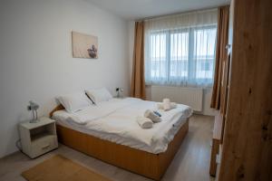 a bedroom with a large bed with towels on it at Barrique 30 - Breakfast Delivered & Minibar - Free parking - Mall Area in Braşov