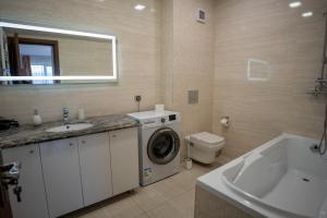 a bathroom with a washing machine and a sink at Barrique 30 - Breakfast Delivered & Minibar - Free parking - Mall Area in Braşov +43 photos