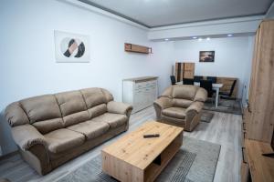 a living room with two couches and a coffee table at Barrique 30 - Breakfast Delivered & Minibar - Free parking - Mall Area in Braşov