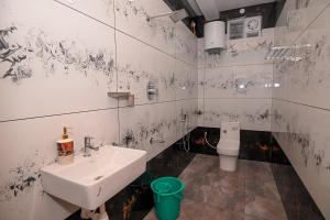 a bathroom with a sink and a toilet at Verdant Crestwood Nilgiris in Coonoor