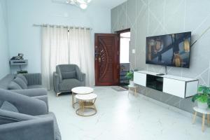 a living room with a tv on a wall at Sukruthi service apartment 3BHK in Mangalore