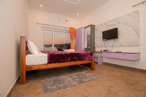 a bedroom with a bed and a tv in a room at Verdant Crestwood Nilgiris in Coonoor