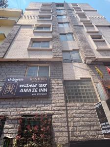 a tall building with a sign on the side of it at Restora Amaze Inn in Bangalore