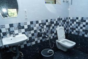 a bathroom with a sink and a toilet at Sukruthi service apartment 3BHK in Mangalore +35 photos