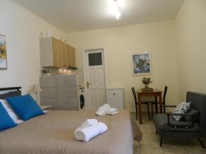 a bedroom with a bed with towels on it at Perakis Apartments in Hydra
