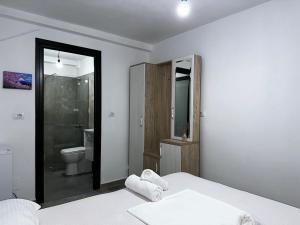 a bedroom with a bed and a bathroom with a toilet at Vila Laura in Ksamil +80 photos