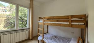 a bedroom with two bunk beds and a window at Monterosso - Apartment in Monterosso al Mare