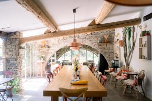 a dining room with a long wooden table and chairs at Domaine Les Mésanges in Saint-Tropez