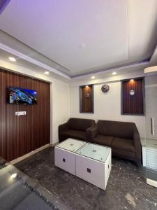 a living room with two couches and a coffee table at Restora Amaze Inn in Bangalore