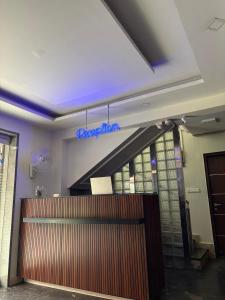 a sign that is on the ceiling above a door at Restora Amaze Inn in Bangalore