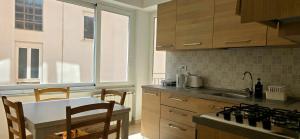 a kitchen with a sink and a table with chairs at Monterosso - Apartment in Monterosso al Mare