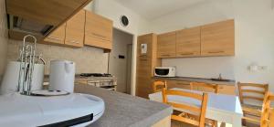a kitchen with wooden cabinets and a counter top at Monterosso - Apartment in Monterosso al Mare
