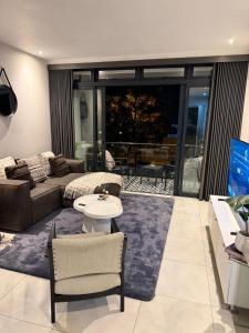 a living room with a couch and a table at The paramount houghton Zayna in Johannesburg