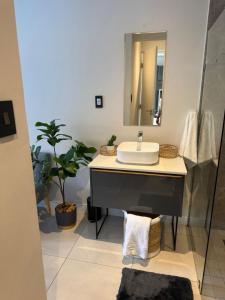 a bathroom with a sink and a mirror at The paramount houghton Zayna in Johannesburg +16 photos