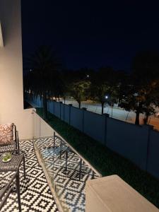 a balcony with a table and a fence at night at The paramount houghton Zayna in Johannesburg