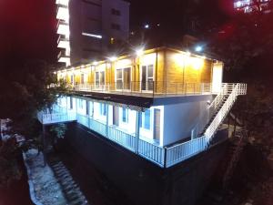 a building with a swimming pool at night at Eden Resort By Live Inn in Lansdowne