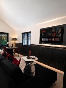a living room with a couch and a table at Holly Tree Luxury Lodge in Skipwith