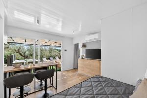 a dining room and living room with a table and chairs at Olive Spa Oasis with Private Jacuzzi and Summer Kitchen in Orasac